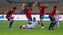 Pemain Kosovo Vedat Muriqi (tengah) ditangani oleh para pemain Kosovo pada pertandingan Grup B babak kualifikasi Piala Dunia 2022 antara di Stadion La Cartuja, Seville, Spanyol, Rabu (31/3/2021). Spanyol menang 3-1. (AP Photo/Miguel Angel Morenatti)