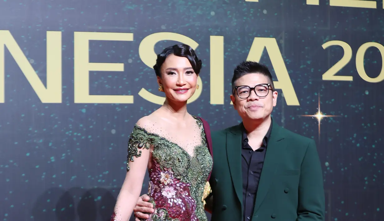 Artika Sari Devi hadirkan vibes ala Puteri Indonesia dengan kebaya off shoulder hijau olive dan burgundy. Dipadu dengan batik bermotif bunga dan selendang burgundy yang kontras [Budi Santoso]