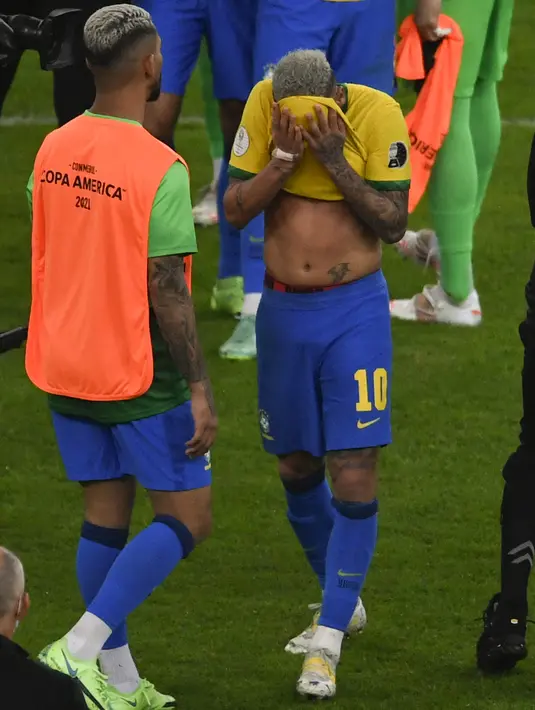 Penyerang Brasil, Neymar menutup wajahnya saat menangis usai pertandingan melawan Argentina pada final Copa America 2021 di stadion Maracana di Rio de Janeiro, Brasil, Minggu (11/7/2021). Ia menangis usai Brasil dikalahkan Argentina 1-0. (AFP/Mauro Pimentel)