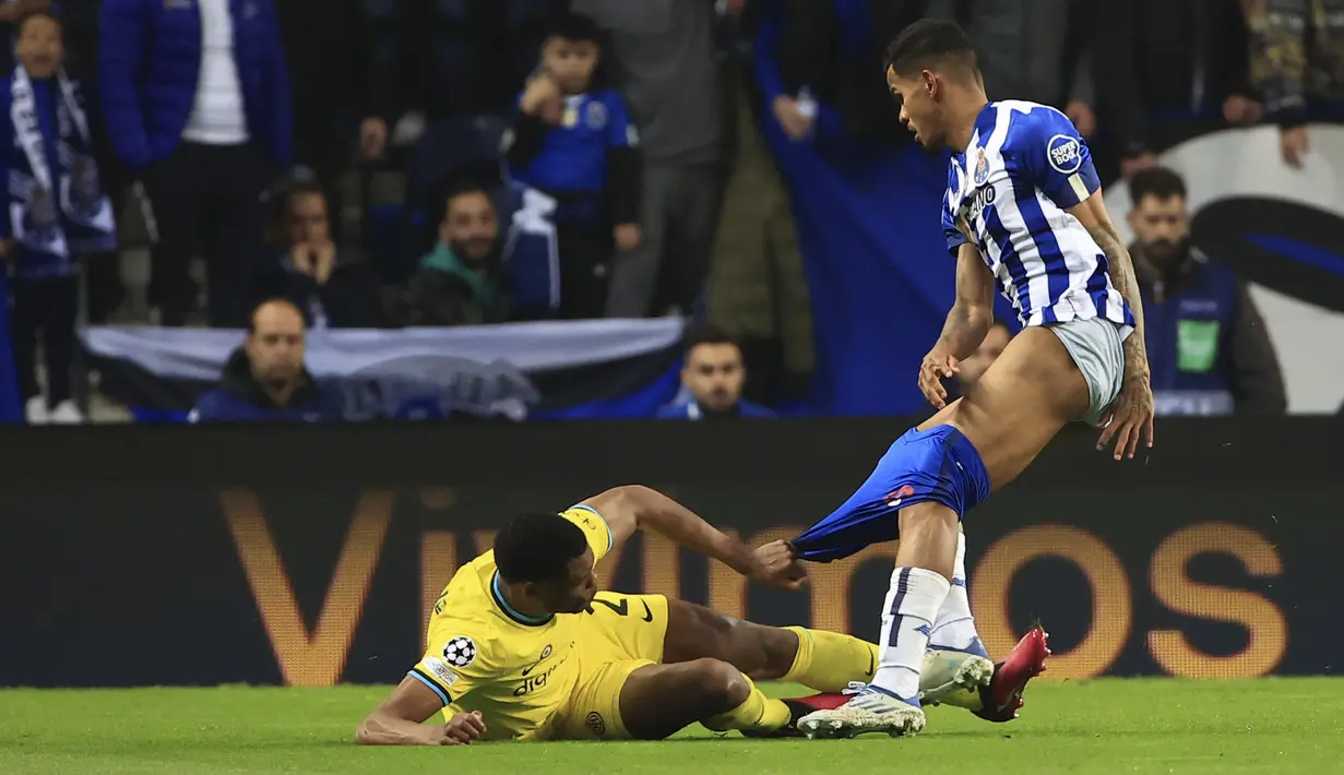 Pemain Inter Milan, Denzel Dumfries (kiri) berusaha merebut bola dari pemain Porto, Galeno dengan menarik celananya hingga melorot pada laga leg kedua 16 besar Liga Champions 2022/2023 di Drago Stadium, Porto, Rabu (15/03/2023) WIB. (AP Photo/Luis Vieira)