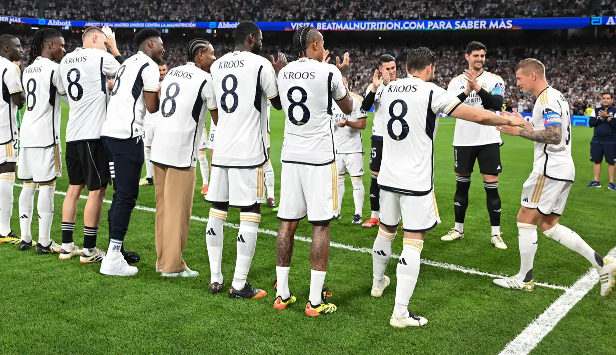Para pemain Real Madrid, yang mengenakan kostum bernomor punggung 8, dan para pemain Betis memberikan guard of honour untuk Toni Kroos sebelum pertandingan. (JAVIER SORIANO / AFP)