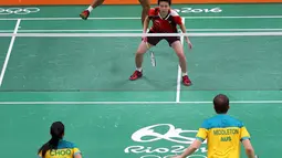 Pebulutangkis ganda campuran Indonesia, Tontowi Ahmad/Liliyana Natsir menahan serangan Robin Middleton/Leanne Choo (Australia) pada laga perdana Grup C Olimpiade Rio 2016, Kamis (11/8). Tontowi/Liliyana unggul 21-7 21-8. (REUTERS/Marcelo del Pozo)