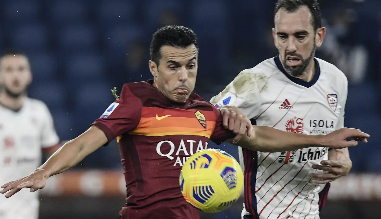 Striker AS Roma, Pedro (kiri) menguasai bola dibayangi bek Cagliari, Diego Godin pada laga Liga Italia 2020/2021 di Olympic Stadium, Roma (23/12/2020). Pedro yang kini menjalani musim kedua bersama Lazio tercatat pernah membela Chelsea selama 5 musim mulai 2015/2016 hingga 2019/2020. Pada awal musim 2020/2021 ia hengkang ke AS Roma dengan status bebas transfer. Hanya bertahan semusim, ia hijrah ke sesama tim ibu kota, Lazio pada 2022/2023. (AFP/Filippo Monteforte)