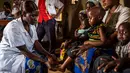 Seorang perawat memeriksa seorang anak saat program pencegahan kurang gizi yang disponsori oleh World Food Program di Pusat kesehatan di Mbau, Republik Demokratik Kongo (15/11). (AFP/ Eduardo Soteras)