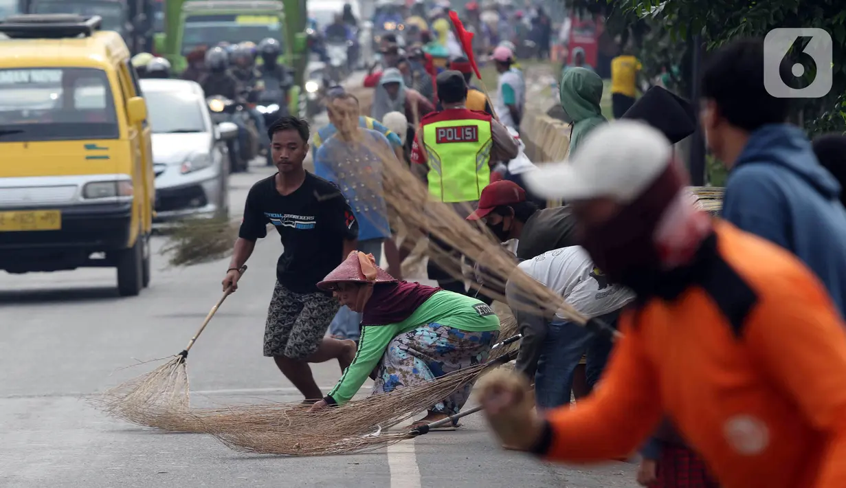 <p>Sejumlah warga berebut sedekah pemberian pengendara kendaraan bermotor di kawasan Jembatan Sewo, Indramayu, Jawa Barat, Jumat (29/4/2022). Aksi mengambil uang sedekah menggunakan sapu meningkat saat puncak arus mudik. (Liputan6.com/Herman Zakharia)</p>