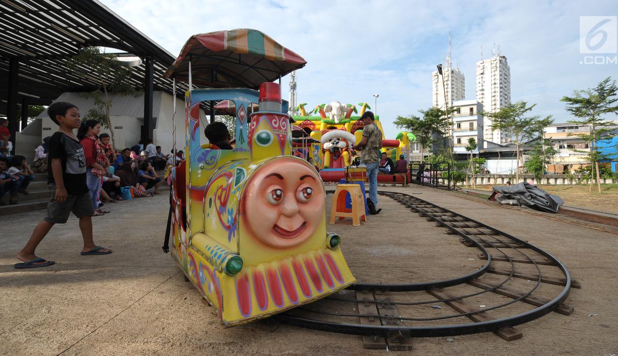 Seorang anak menanti giliran naik kereta di area RTH Kalijodo, Rabu (20/6). Banyaknya pilihan permainan buat anak-anak menjadikan RTH Kalijodo memiliki daya tersendiri untuk menghabiskan waktu libur bersama keluarga. (Lipiutan6.com/Helmi Fithriansyah)