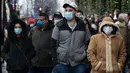 Pembeli, beberapa mengenakan masker, mengantre untuk memasuki department store Selfridges menjelang penjualan Boxing Day di pusat kota London, Minggu (26/12/2021).  'Boxing Day' adalah hari saat toko-toko di Inggris menggelar diskon besar-besaran, sehari setelah Natal. (Niklas HALLE'N / AFP)