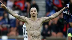 Penyerang Paris Saint-Germain Zlatan Ibrahimovic merayakan selebrasi pamer tato saat timnya bermain imbang 2-2 dengan Caen pada 14 Februari 2015. (AFP Photo/Kenzo Tribouillard)