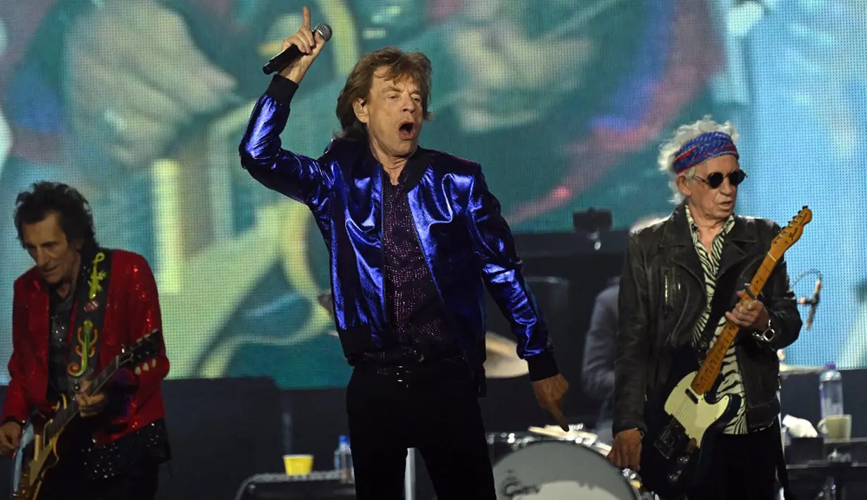 Vokalis band rock Inggris The Rolling Stones Mick Jagger (tengah), gitaris Keith Richards (kanan), dan Ron Wood tampil pada konser Stones Sixty European Tour di Veltins Arena, Gelsenkirchen, Jerman, 27 Juli 2022. The Rolling Stones akan bermain di seluruh Eropa musim panas ini untuk merayakan 60 tahun spesial bersama – Mick, Keith, dan Ronnie. (INA FASSBENDER/AFP)