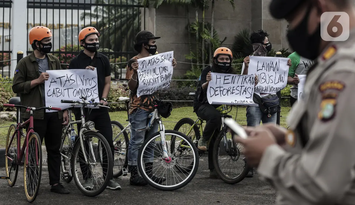 Mahasiswa Pecinta Alam saat melakukan aksi bersepeda dan menggelar tenda di depan Gedung MPR/DPR/DPD, Jakarta, Rabu (15/7/2020). Dalam aksinya mereka menuntut penghapusan RUU Cipta Kerja atau Omnibus Law. (Liputan6.com/Johan Tallo)