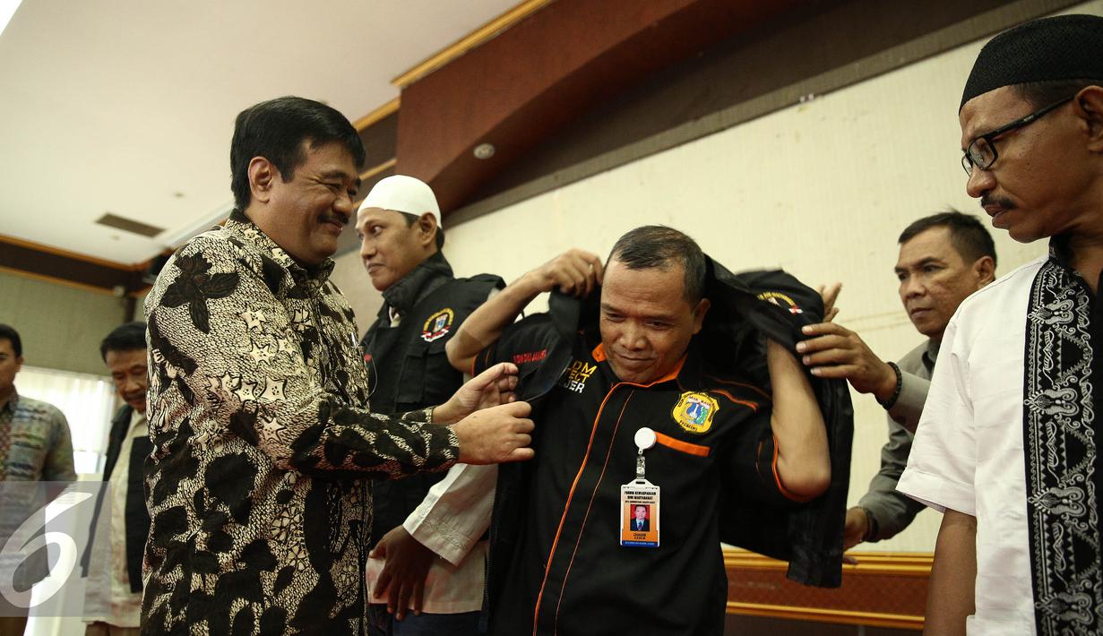 Wakil Gubernur DKI, Djarot Saiful Hidayat selaku pembina Forum Kewaspadaan Dini Masyarakat (FKDM) memberikan rompi saat hadir silaturahmi dan buka puasa di Jakarta, Selasa (28/6). (Liputan6.com/Faizal Fanani)