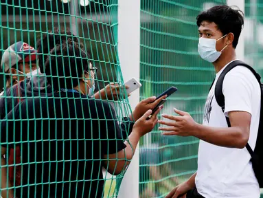 Kiper Timnas Indonesia, Muhammad Riyandi, melakukan wawancara dari balik jaring usai latihan di Lapangan D, Senayan, Jakarta. (Bola.com/ M Iqbal Ichsan)