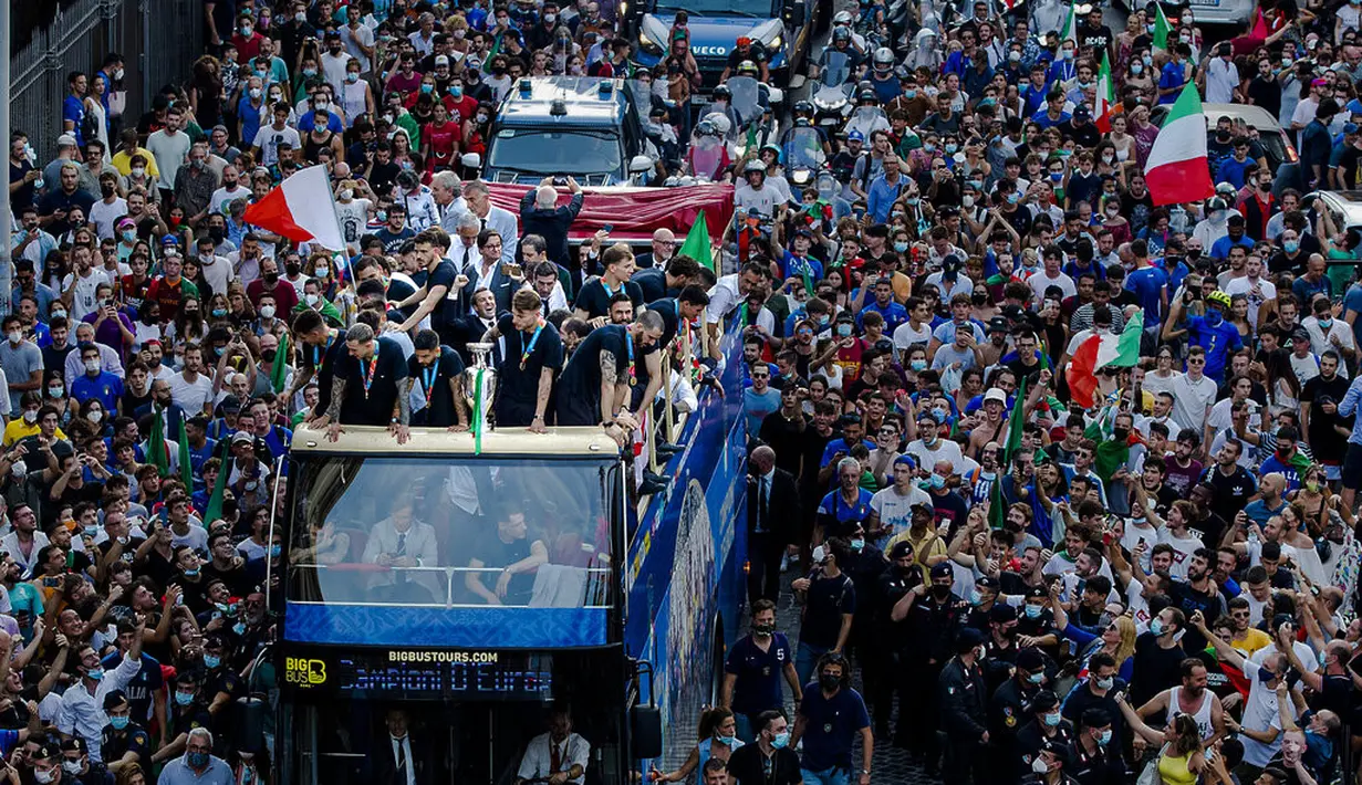 Para pemain Italia berada di atas bus saat perayaan juara Euro 2020 di Roma, Senin (12/7/2021). Italia mengalahkan Inggris 3-2 dalam adu penalti setelah bermain imbang 1-1 pada final Euro 2020 di stadion Wembley di London. (Roberto Monaldo/ Lapresse via AP)
