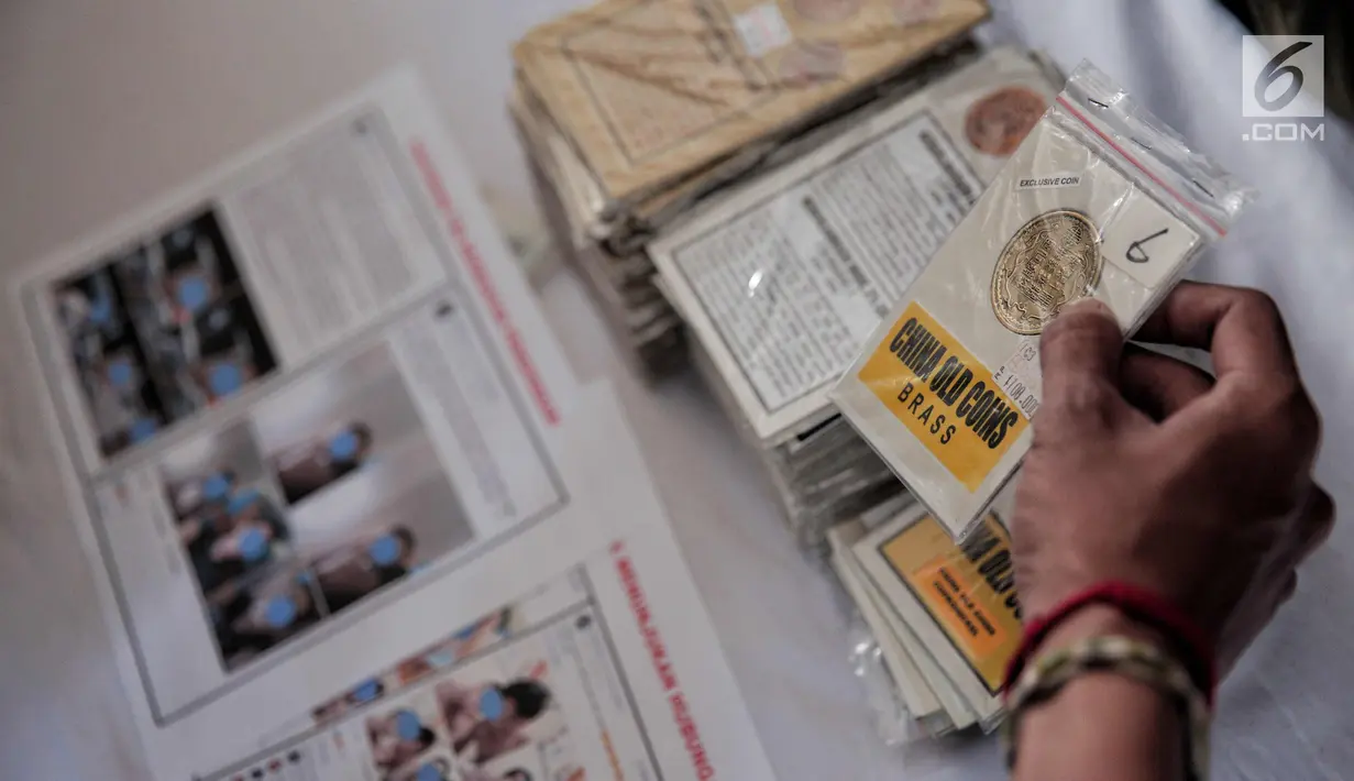 Petugas menunjukkan barang bukti dari penyebar konten pornografi dalam rilis di RS Polri, Jakarta Timur, Jumat (3/11). Pelaku menyebarkan konten itu hanya sebatas untuk mengajak kaum sesama jenis berkencan dan bersenang-senang (Liputan6.com/Faizal Fanani)