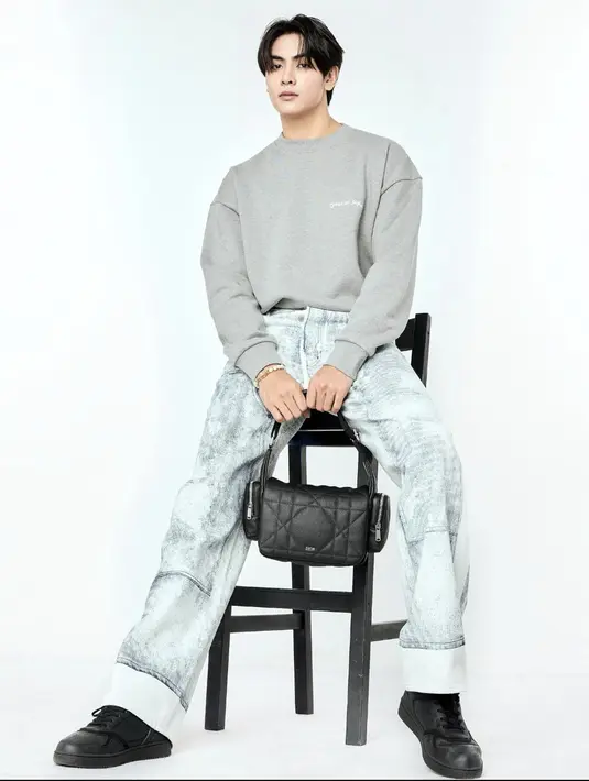 Joong  memadukan DIOR MAXICANNAGE bags dengan sweater dan denim. Aksentuasi tas hadirkan elevansi gaya yang maksimal.  [Foto: Dior]