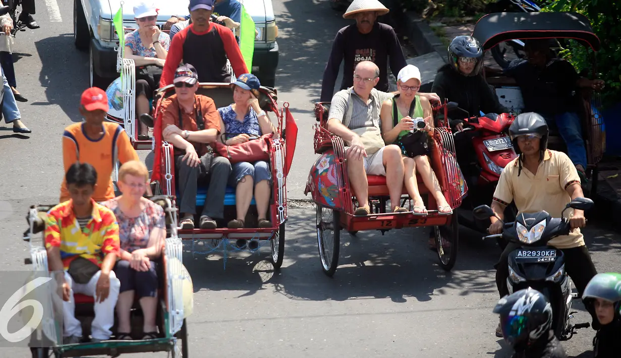 Wisatawan menikmati perjalanan menaiki becak saat mengelilingi kawasan alun alun Kraton Kesultanan Yogyakarta, (4/5). Becak menjadi transportasi ramah lingkungan yang di minati wisatawan karena tidak menimbulkan polusi udara. (Liputan6.com/Boy Harjanto)