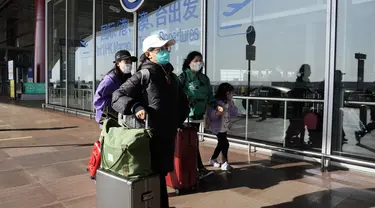 Penumpang yang memakai masker berjalan melalui terminal bandara Ibukota di Beijing, China, Selasa (13/12/2022). Pada Rabu (28/12/2022) AS mengumumkan persyaratan pengujian COVID-19 baru untuk semua pelancong dari China, bergabung dengan negara lain yang memberlakukan pembatasan karena dari lonjakan infeksi. (AP Photo/Ng Han Guan)