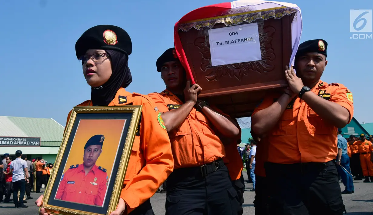 Anggota Basarnas membawa peti jenazah korban jatuhnya helikopter milik basarnas di Lanumad Ahmad Yani, Semarang (3/7). Sebanyak delapan jenazah korban jatunya helikopter Basarnas diserahkan ke pihak keluarga dalam upacara pelepasan. (Liputan6.com/Gholib)
