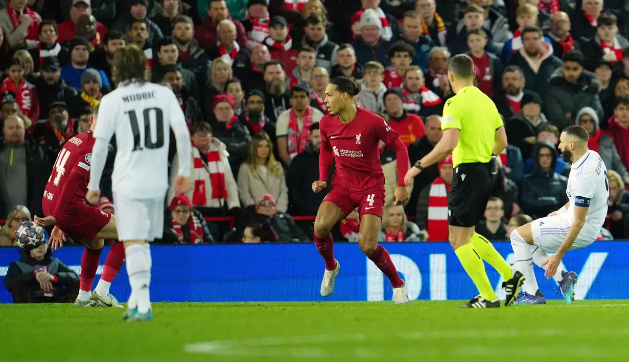 Pemain Real Madrid Karim Benzema (kanan) mencetak gol ke gawang Liverpool pada pertandingan sepak bola leg pertama babak 16 besar Liga Champions di Stadion Anfield, Liverpool, Inggris, 21 Februari 2023. Real Madrid mengalahkan Liverpool dengan skor 5-2. (AP Photo/Jon Super)