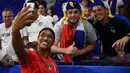 United States' forward Jessica McDonald takes a selfie with supporters  after  the France 2019 Women's World Cup semi-final football match between England and USA, on July 2, 2019, at the Lyon Satdium in Decines-Charpieu, central-eastern France. (Photo by FRANCK FIFE / AFP)
