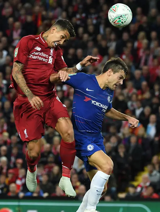 Striker Liverpool, Roberto Firmino berebut bola udara dengan bek Chelsea Cesar Azpilicueta saat bertanding pada babak ketiga Piala Liga Inggris di stadion Anfield (26/9). Chelsea berhasil mengalahkan Liverpool 2-1. (AFP Photo/Paul Ellis)