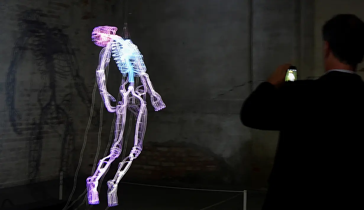 Pengunjung mengambil gambar karya seni buatan seniman Bahamian Tavares Strachan saat pratinjau pers menjelang pembukaan pameran International Venice Biennale di Venesia, Italia, Rabu (8/5/2019). International Venice Biennale ke-58 ini bertema 'May You Live In Interesting Times'. (TIZIANA FABI/AFP)