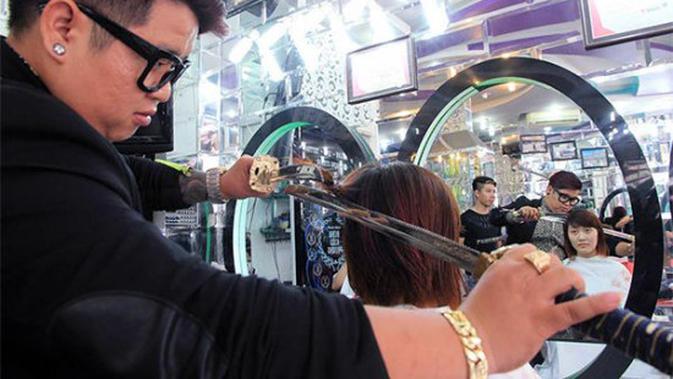 Penata rambut ini punya cara sendiri dalam memotong rambut pelanggannya.