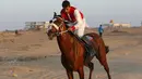 Seorang joki saat mengikuti balap kuda di Rafah, Jalur Gaza, Palestina, Selasa (10/9/2019). Balapan kuda tradisional Palestina tersebut digelar di bekas lokasi bandara Jalur Gaza yang telah hancur. (AFP Photo/Said Khatib)