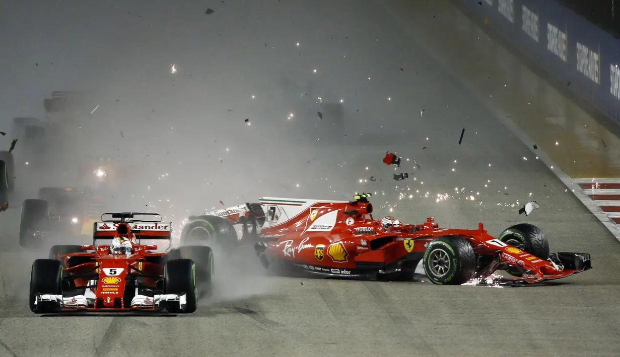 Pebalap Ferrari, Kimi Raikkonen (kanan) mengalami kecelakaan saat balapan F1 GP Singapura di Marina Bay City Circuit (17/9/2017). Duo pebalap Ferrari gagal melanjutkan balapan. (AP/Yong Teck Lim)