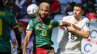 Pemain Timnas Kamerun, Eric Maxim Choupo-Moting (kiri) menguasai bola dibayangi pemain Timnas Serbia, Milos Veljkovic dalam laga matchday kedua Grup G Piala Dunia 2022 di Al Janoub Stadium, Al Wakrah, Qatar, Senin (28/11/2022) sore WIB. (AP/Frank Augstein)