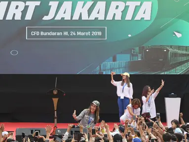 Sejumlah selebriti berswafoto bersama warga jelang peresmian pengoperasian Moda Raya Terpadu Jakarta fase 1 di Kawasan Bundaran HI, Jakarta, Minggu (24/3). Peresmian dilakukan oleh Presiden Joko Widodo, Gubernur DKI Jakarta, Anies Baswedan serta pihak terkait. (Liputan6.com/Helmi Fithriansyah)