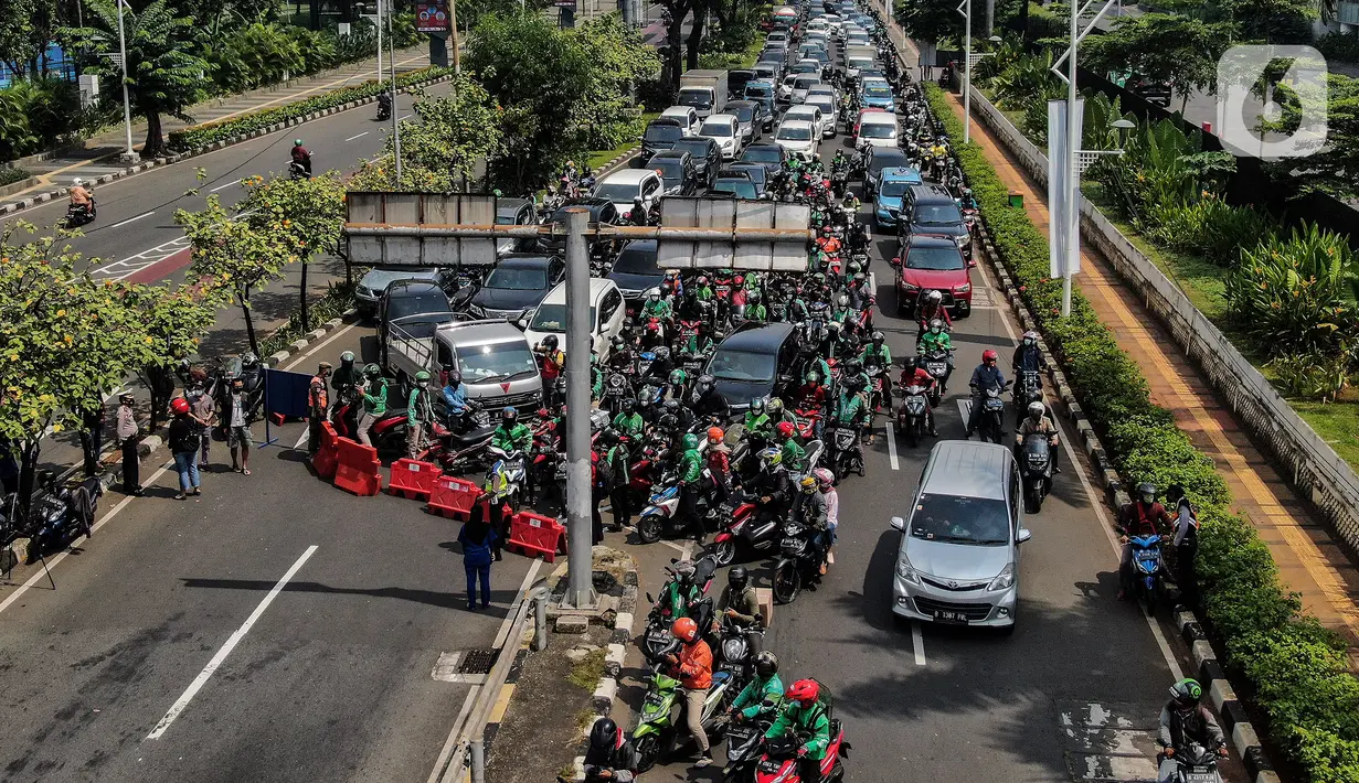 Aparat kepolisian melakukan penyekatan kendaraan di Pemuda, Jakarta Selatan, Kamis (15/7/2021). Polda Metro Jaya menambahkan penyekatan 100 titik yang ada di Jakarta dan sekitarnya pada hari ini selama penerapan Pemberlakuan Pembatasan Kegiatan Masyarakat (PPKM) darurat. (Liputan6.com/Johan Tallo)
