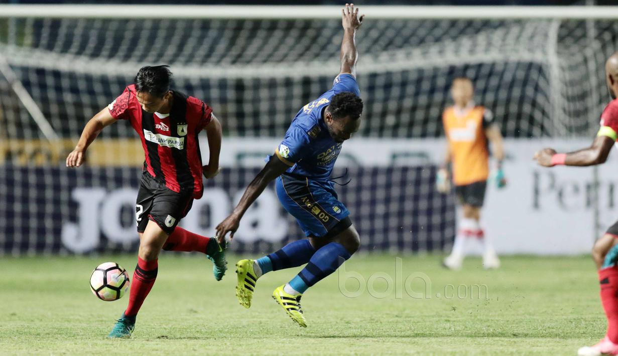 Michael Essien (kanan) berebut bola dengan pemain Persipura, M Tahir pada lanjutan Liga 1 2017 di Stadion GBLA, Bandung, Minggu (7/5/2017). Persib menang 1-0. (Bola.com/Nicklas Hanoatubun)