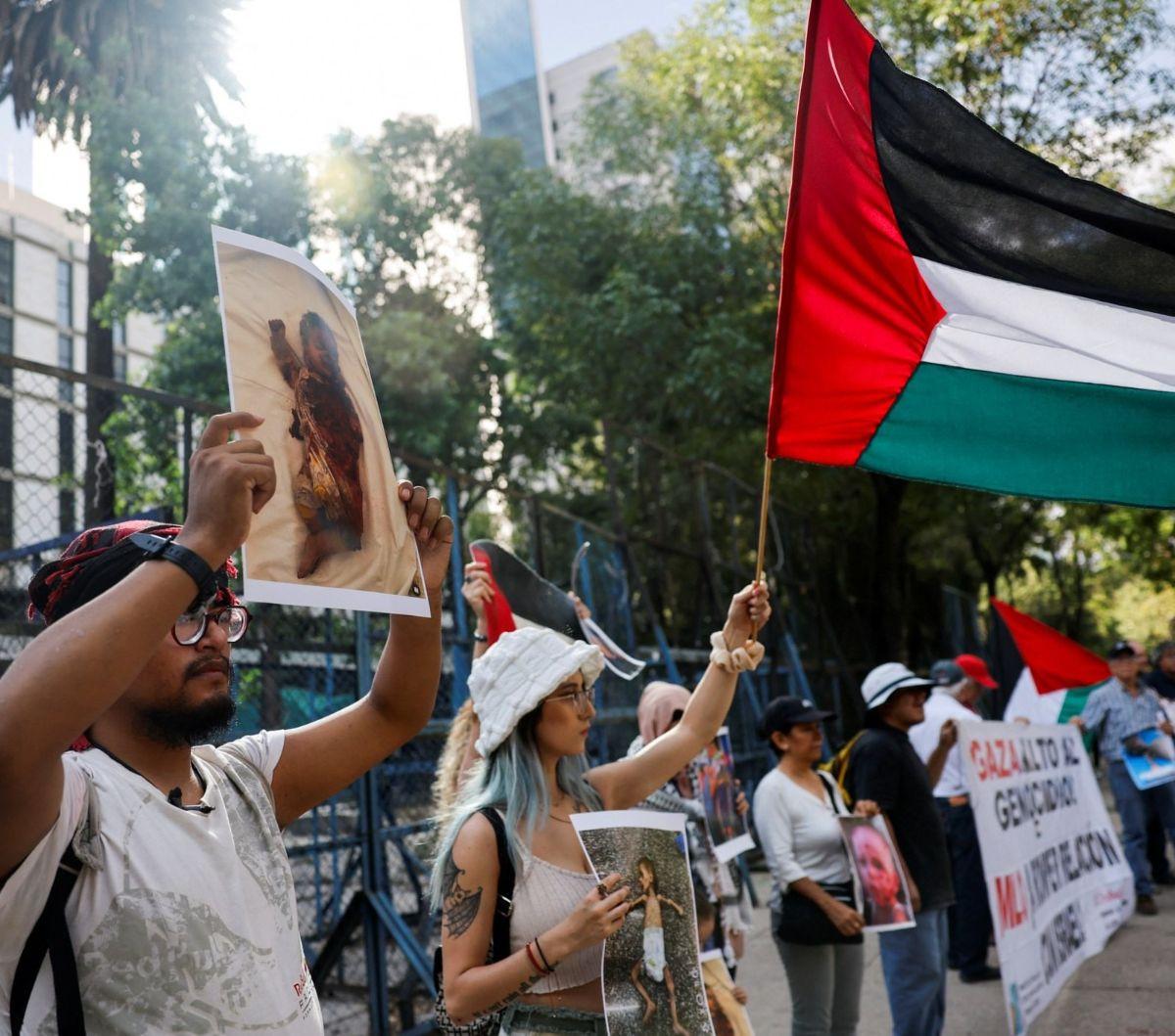 Pengunjuk rasa terlihat mengibarkan bendera Palestina saat mengecam serangan militer Israel di kota Rafah, Gaza. <br><br>Pada Jumat (31/5/2024) lalu, militer zionis Israel melancarkan serangan brutal di sejumlah wilayah Kota Gaza yang sudah ditargetkan. 