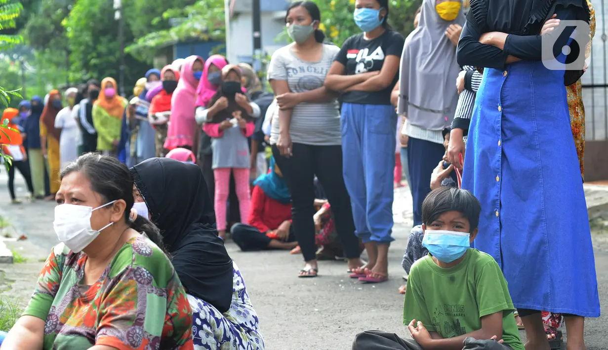 Warga terdampak Covid-19 antre mengambil bahan pangan gratis di Kompleks Bumi Menteng Asri, Rt 01/18, Kelurahan Menteng, Bogor, Kamis (21/5/2020).  Bahan pangan tersebut disediakan secara swadaya warga setempat dan sudah berjalan selama Bulan Ramadan. (merdeka.com/Arie Basuki)