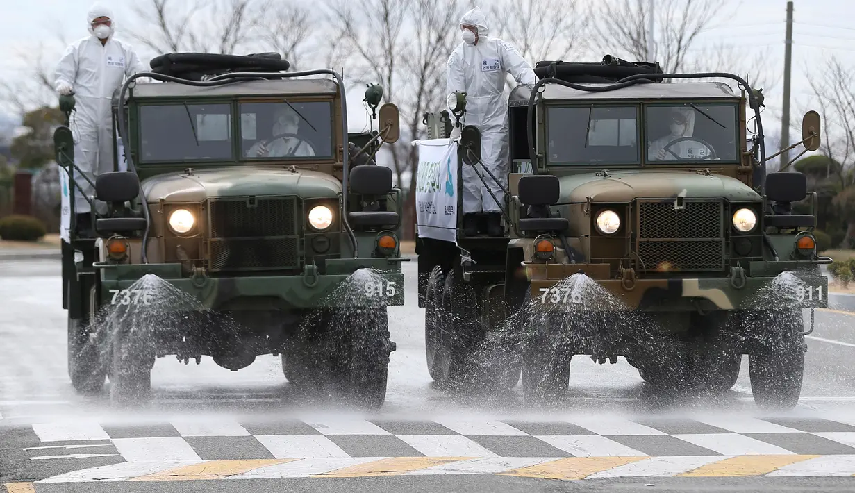 Truk-truk tentara Korea Selatan menyemprotkan desinfektan di sebuah jalan di Ulsan, Selasa (3/3/2020). Seoul mengerahkan tentara untuk menyemprotkan disinfektan di jalan dan gang-gang untuk mencegah penyebaran virus corona COVID-19. (Kim Young-tae/Yonhap via AP)