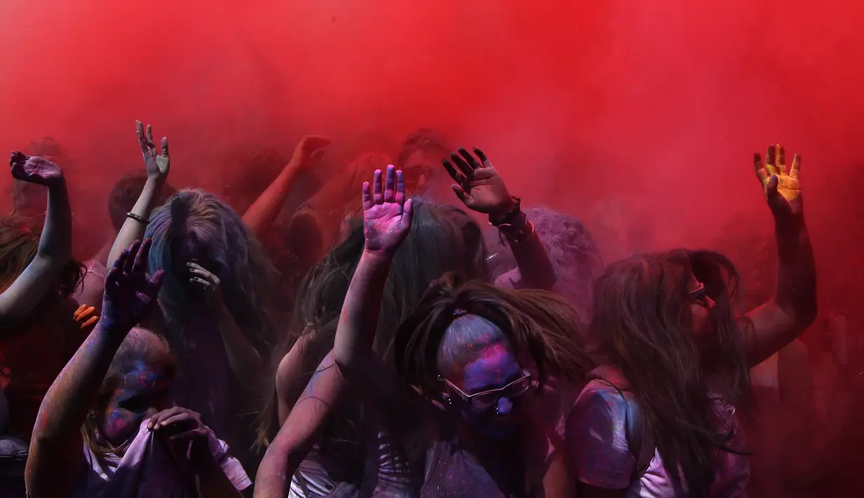 Peserta Festival Holi melemparkan serbuk berwarna di Santa Coloma de Gramenet, Spanyol, Minggu (28/5). Festival ini dibuat setelah festival musim semi Hindu Holi, yang dirayakan di utara dan timur India. (AP Photo / Manu Fernandez)