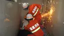 Kombinasi foto yang memperlihatkan saat seorang pria terjebak di mesin cuci (atas) dan saat petugas pemadam kebakaran berusaha menolong pria tersebut di Fuqing, China, 29 Mei 2016. (REUTERS/Stringer)