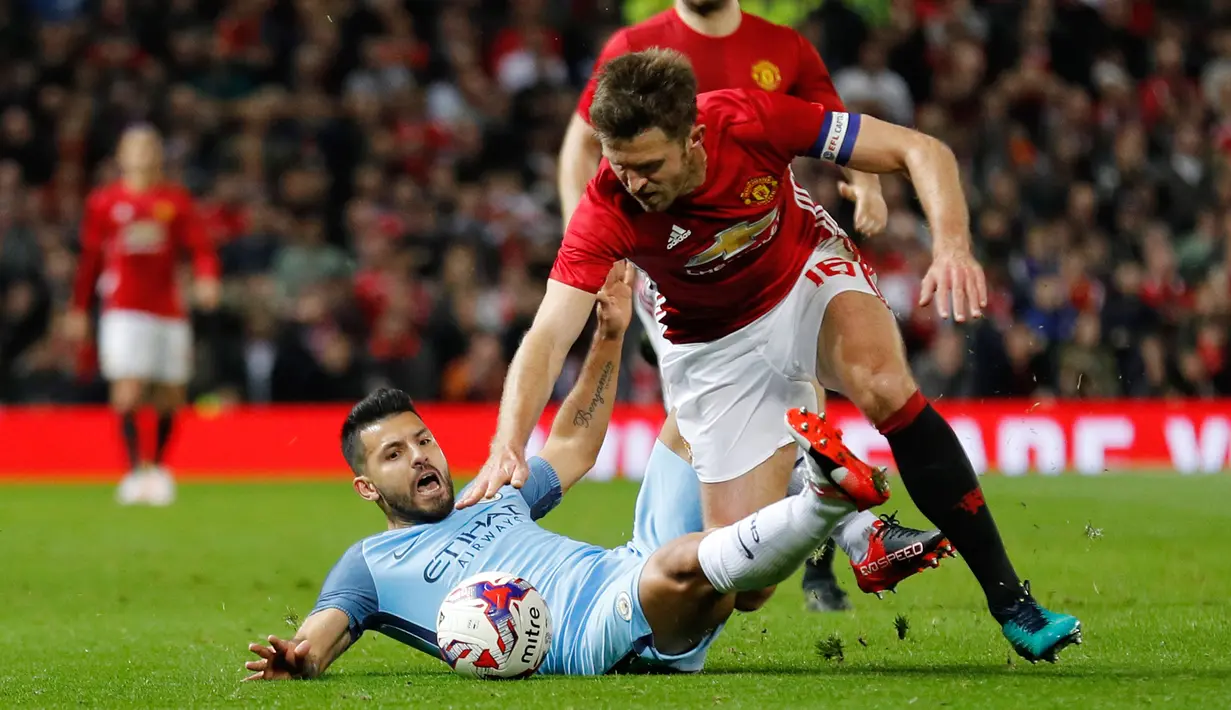 Sergio Aguero berebut bola dengan pemain MU, Michael Carrick pada pertandingan Piala Liga Inggris di Stadion Old Trafford, Manchester, Inggris (26/10). MU berhasil menang dikandang sendiri dengan skor 1-0 atas City. (Reuters/Jason Cairnduff)
