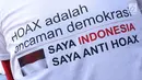 Tulisan sosialisasi anti hoax yang digelar di kawasan Bundaran Hotel Indonesia, Jakarta, Minggu (18/11). PB HMI mensosialisasikan Hoax sebagai ancaman demokrasi di Indonesia. (Liputan6.com/Helmi Fithriansyah)