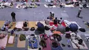 Warga beristirahat di ruang pameran setelah dievakuasi di Hangzhou di provinsi Zhejiang, China timur (25/7/2021). Pemerintah setempat mengatakan angin topan In-fa telah menumbangkan sekitar 30.000 pohon, 268 papan reklame, dan rambu-rambu toko. (Chinatopix via AP)