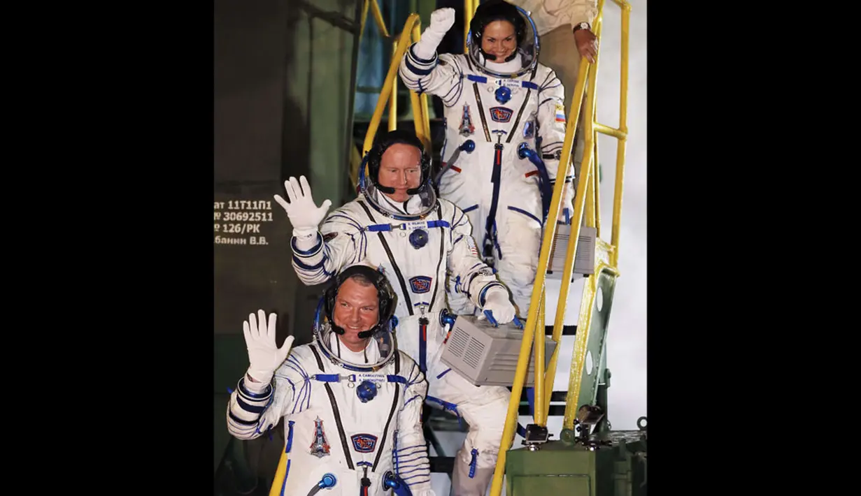 Awak Stasiun Luar Angkasa Internasional, Elena Serova, Barry Wilmore, Alexander Samokutyaev (dari atas ke bawah) bersiap naik pesawat ruang angkasa Soyuz TMA-14M  di Baikonur Cosmodrome, Kazakhstan, (26/9/2014). (REUTERS/Yuri Kochetkov/Pool)