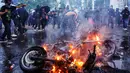 Para pengunjuk rasa membakar sepeda motor dalam sebuah demonstrasi menentang revisi Undang-Undang Tentara Nasional Indonesia (UU TNI) di depan Kompleks Parlemen di Jakarta pada 27 Maret 2025. (AZWAR IPANK/AFP)
