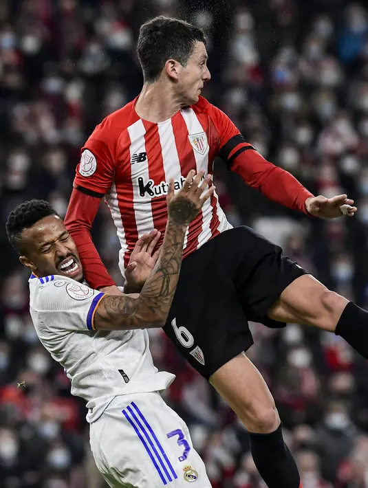 Bek Real Madrid Eder Militao berebut bola dengan gelandang Athletic Bilbao Mikel Vesga pada perempat final Copa del Rey di San Mames, Jumat (4/2/2022) dinihari WIB. Real Madrid tersisih dari Copa del Rey setelah kalah 0-1 dari Athletic Bilbao. (AP Photo/Alvaro Barrientos)