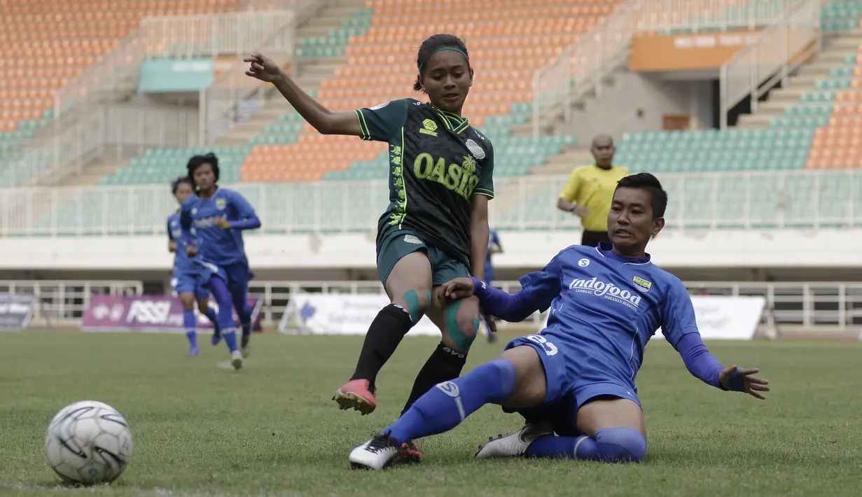 Gelandang Tira Persikabo Putri, Hanipah Halimatusyadiah, berebut bola dengan bek Persib Bandung Putri, Vivi Oktavia, pada laga Liga 1 Putri 2019 di Stadion Pakansari, Bogor, Kamis (31/10). Persikabo Putri bermain imbang 1-1 atas Persib Putri. (Bola.com/Yoppy Renato)