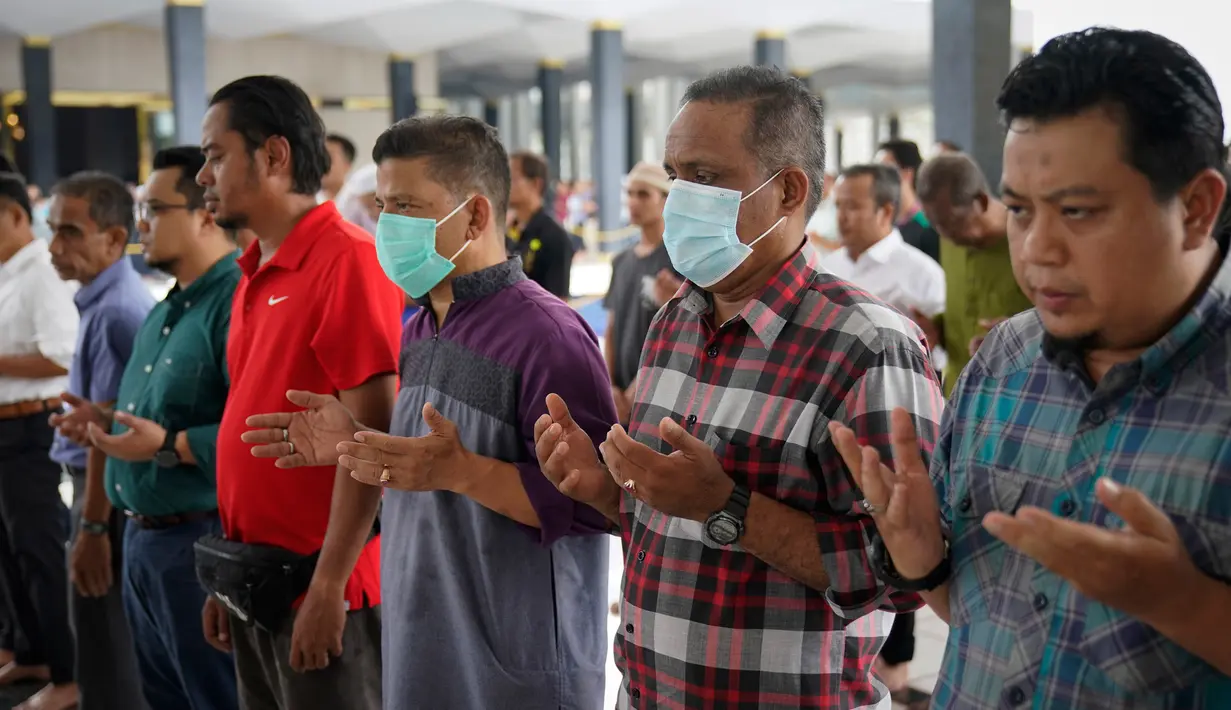 Umat muslim Malaysia berdoa saat melaksanakan ibadah salat Jumat dengan mempersingkat khotbah di Masjid Nasional di Kuala Lumpur, Jumat (13/3/2020). Malaysia memutuskan tetap melakukan salat Jumat, tetapi dengan pedoman yang ketat pasca-penyebaran virus corona COVID-19. (AP Photo/Vincent Thian)