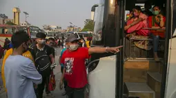 Seorang sopir menunjukkan bus kepada penumpang untuk kembali ke desa mereka sehari sebelum lockdown di Kathmandu, Rabu (28/4/2021). Puluhan ribu orang meninggalkan ibu kota Nepal sehari menjelang lockdown selama 15 hari yang diberlakukan karena melonjaknya kasus COVID-19 (AP Photo/Niranjan Shrestha)