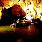 Wisata menyusuri sungai di dalam gua (cave tubing) menyajikan pemandangan unik.