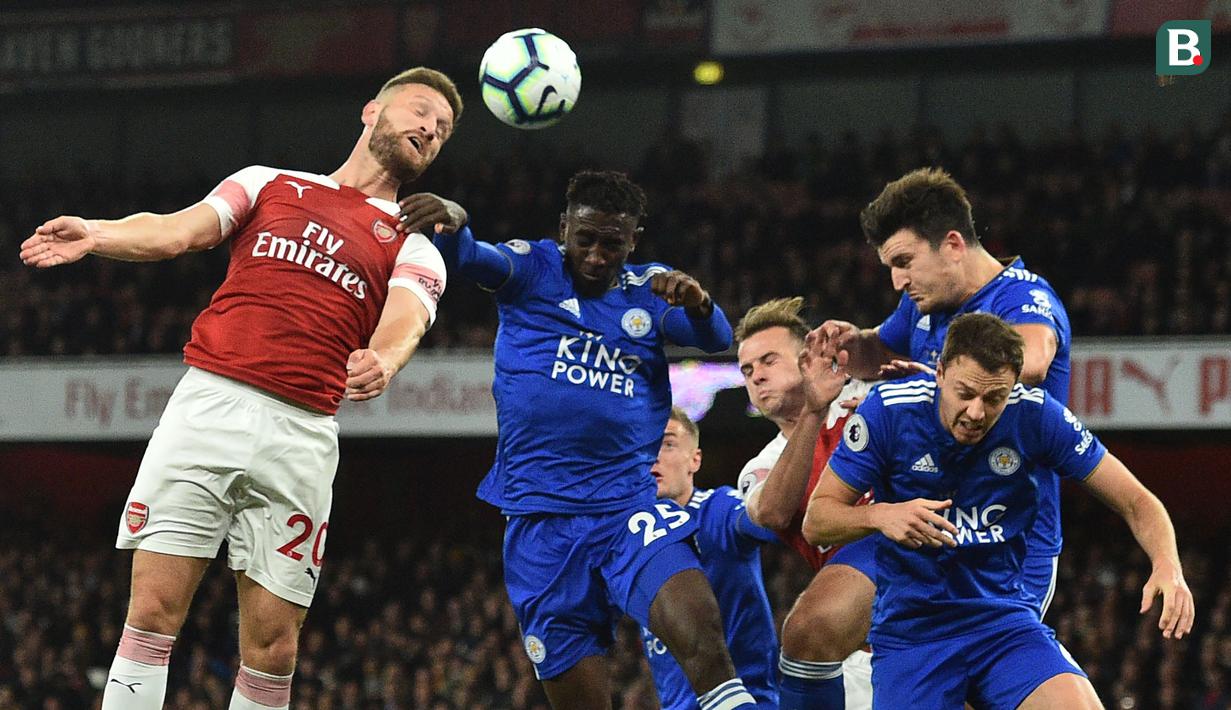 Bek Arsenal, Shkodran Mustafi, duel udara dengan gelandang Leicester, Wilfred Ndidi, pada laga Premier League Inggris di Stadion Emirates, London, Senin (22/10). Arsenal menang 3-1 atas Leicester. (AFP/Glyn Kirk)