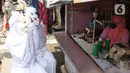 Petugas Kecamatan Larangan berkeliling mengenakan pakaian pocong saat melakukan sosialisasi di Pasar Cipadu, Kota Tangerang, Rabu (16/9/2020). Pocong ini bentuk sosialiasi agar warga memperhatikan perilaku 3M COVID, yaitu memakai masker, menjaga jarak dan mencuci tangan. (Liputan6.com/Angga Yuniar)